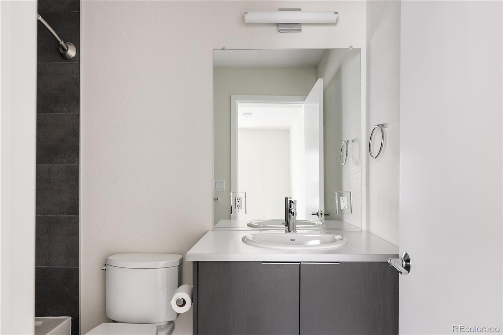 1179 South Reed Street Lakewood, CO 80232 - Photo 20 of 27 a bathroom with a sink and a mirror