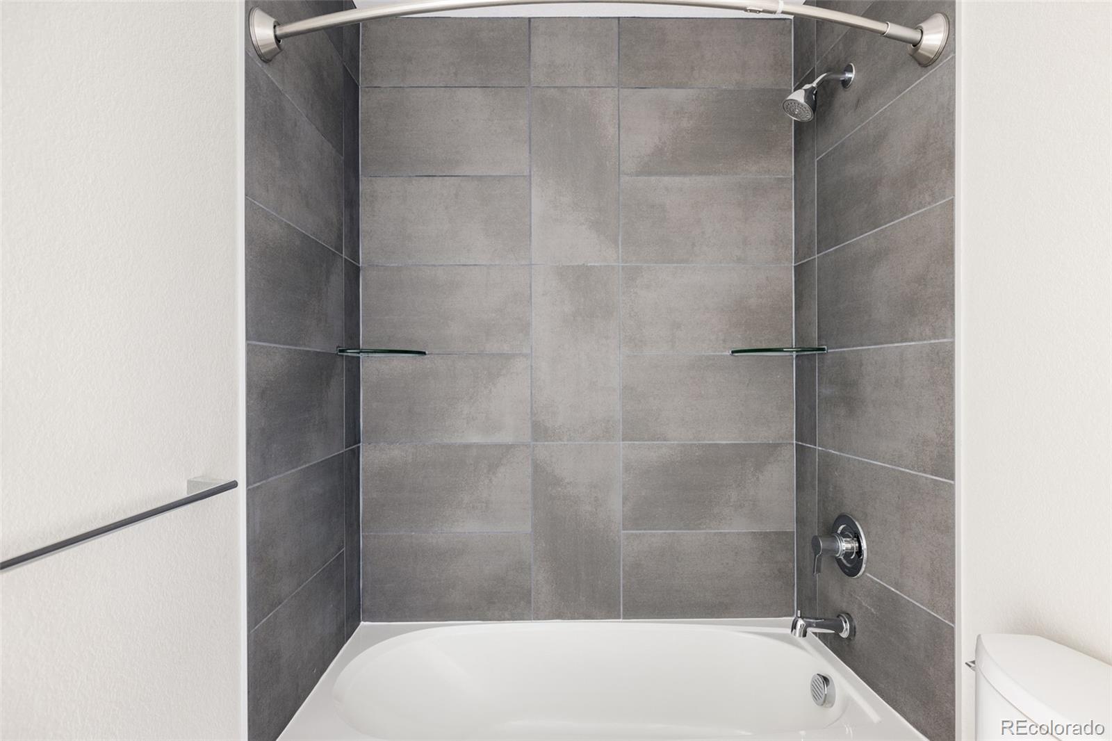 1179 South Reed Street Lakewood, CO 80232 - Photo 21 of 27 a bathroom with a tub