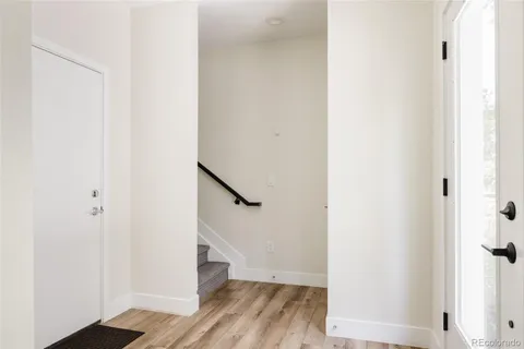 a view of a hallway with wooden floor