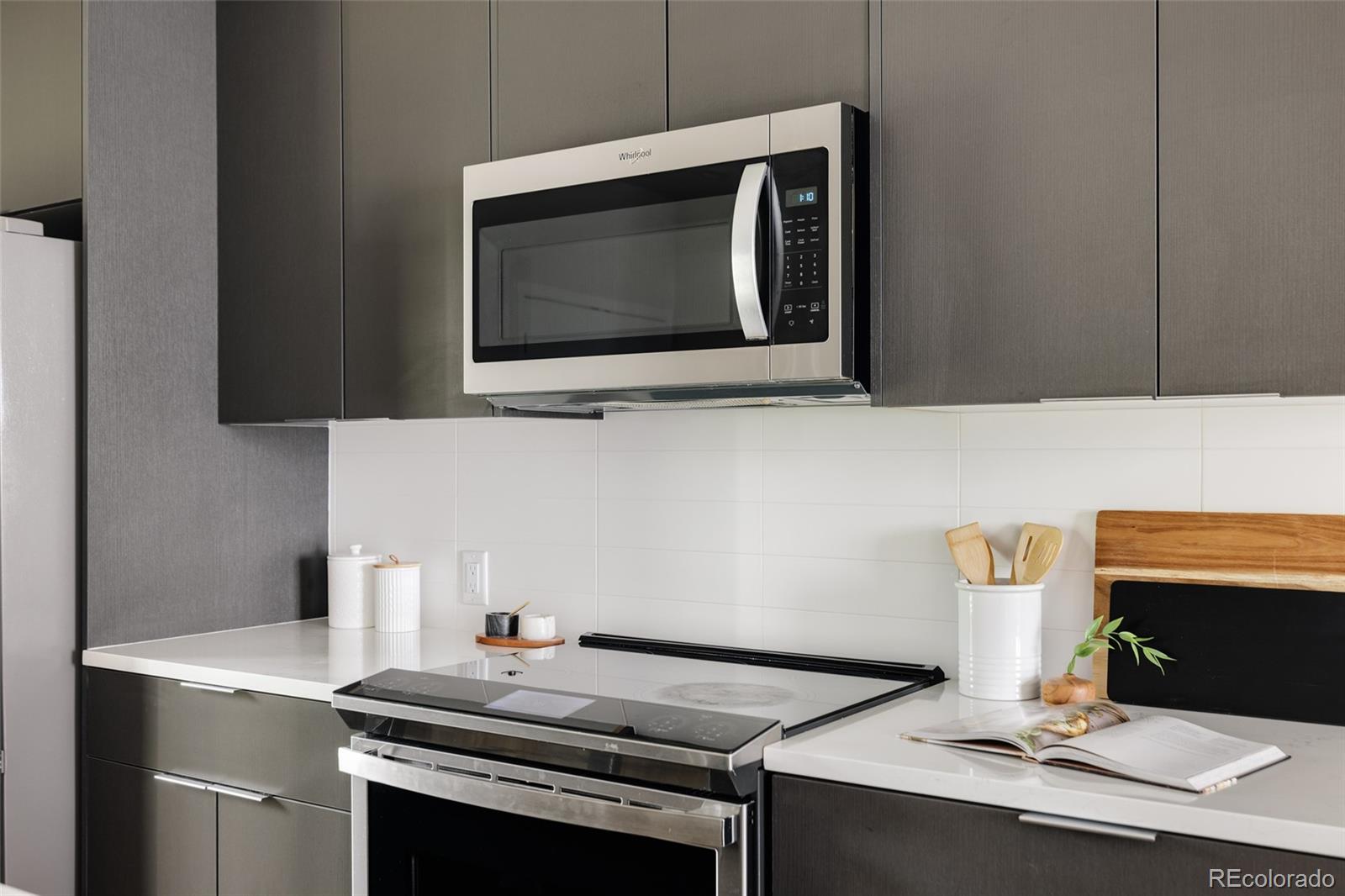 1179 South Reed Street Lakewood, CO 80232 - Photo 5 of 27 a kitchen with a stove and a microwave