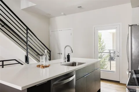 a kitchen with a sink and a refrigerator