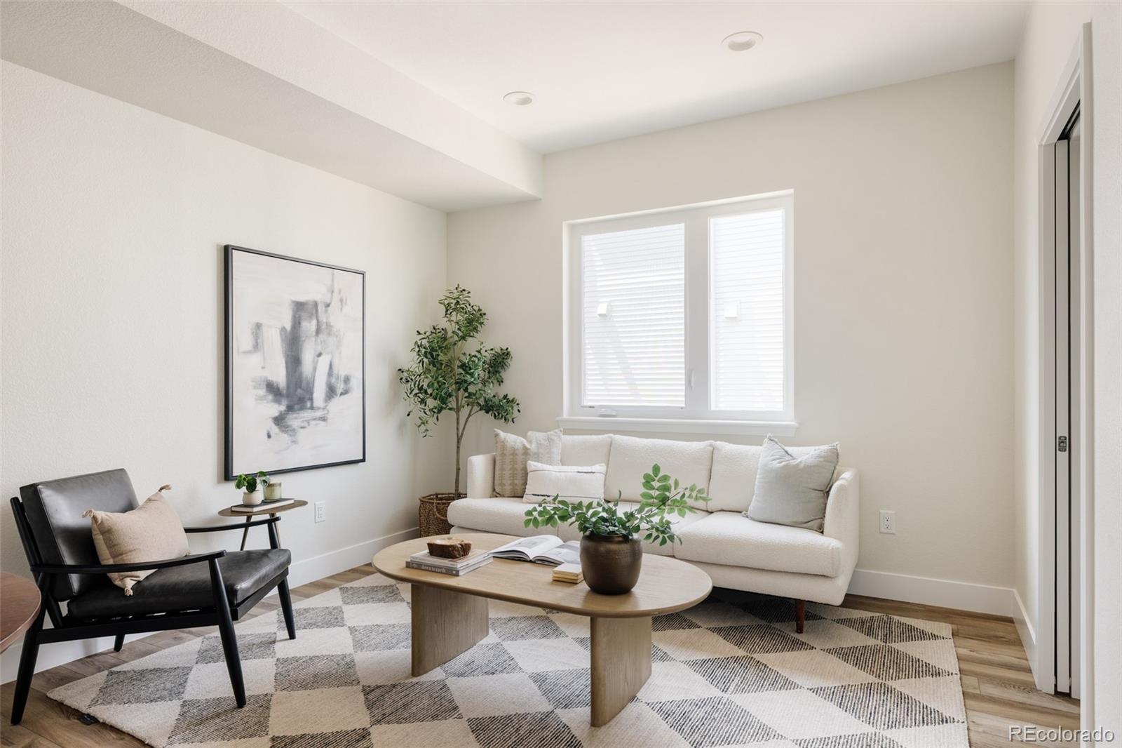 1179 South Reed Street Lakewood, CO 80232 - Photo 9 of 27 a living room with furniture and a potted plant