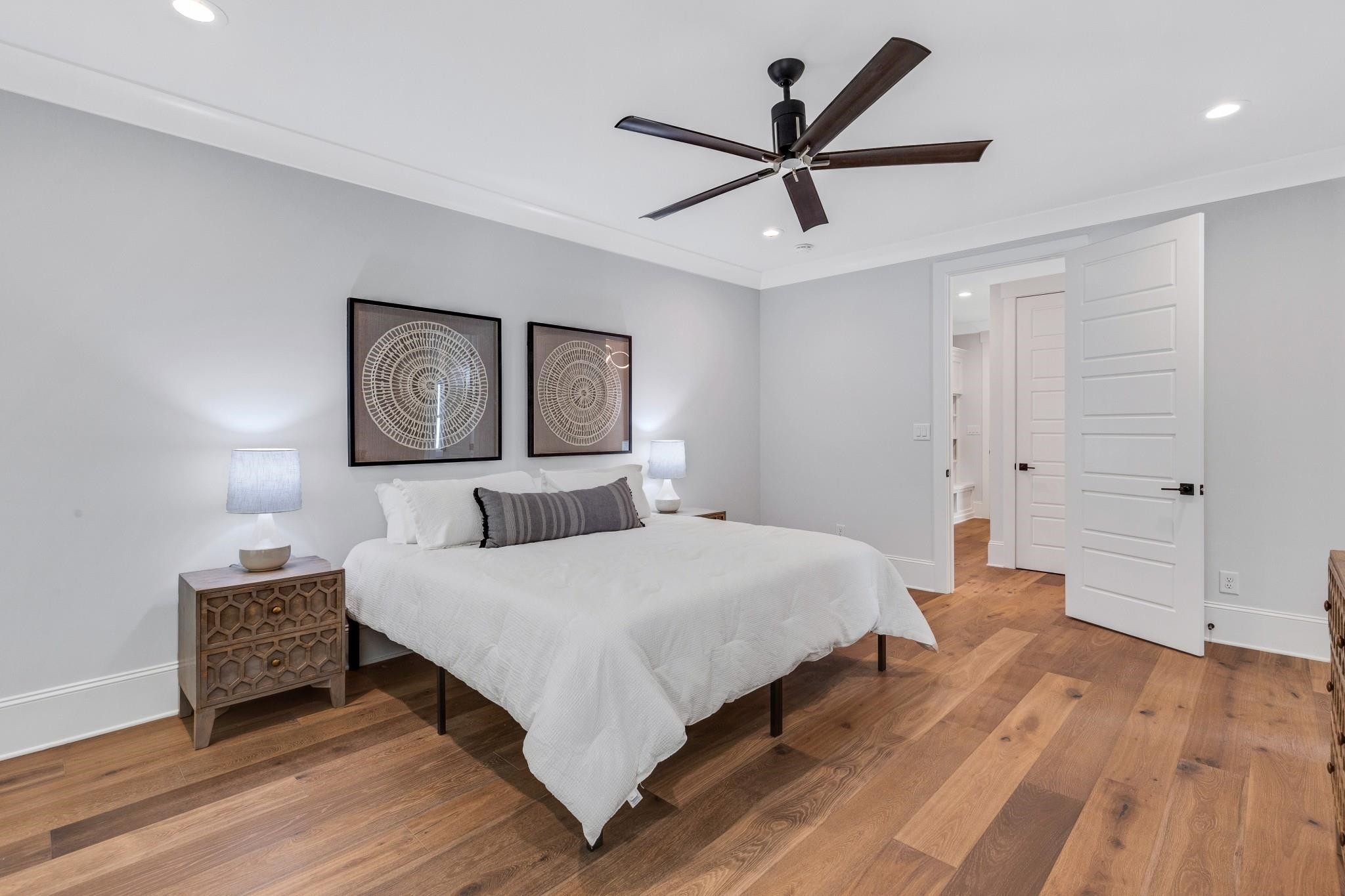 115 Crestview Road Raleigh, NC 27609 - Photo 19 of 42 a bedroom with a large bed a lamp and a chandelier