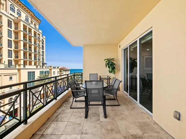 a view of a chairs and table in the balcony