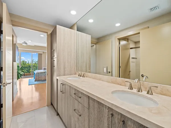 a bathroom with a glass shower door and a window