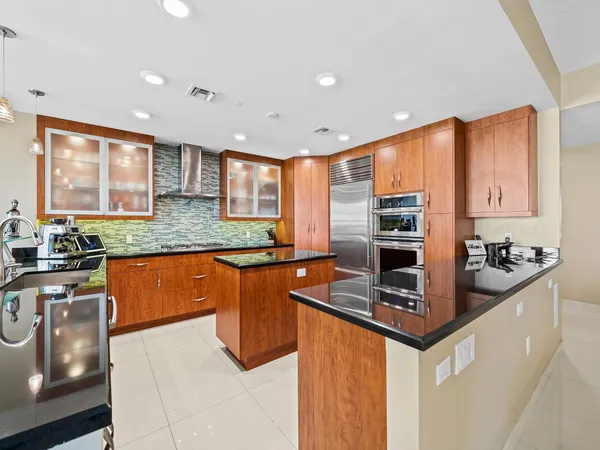 a kitchen with stainless steel appliances granite countertop a sink stove and refrigerator
