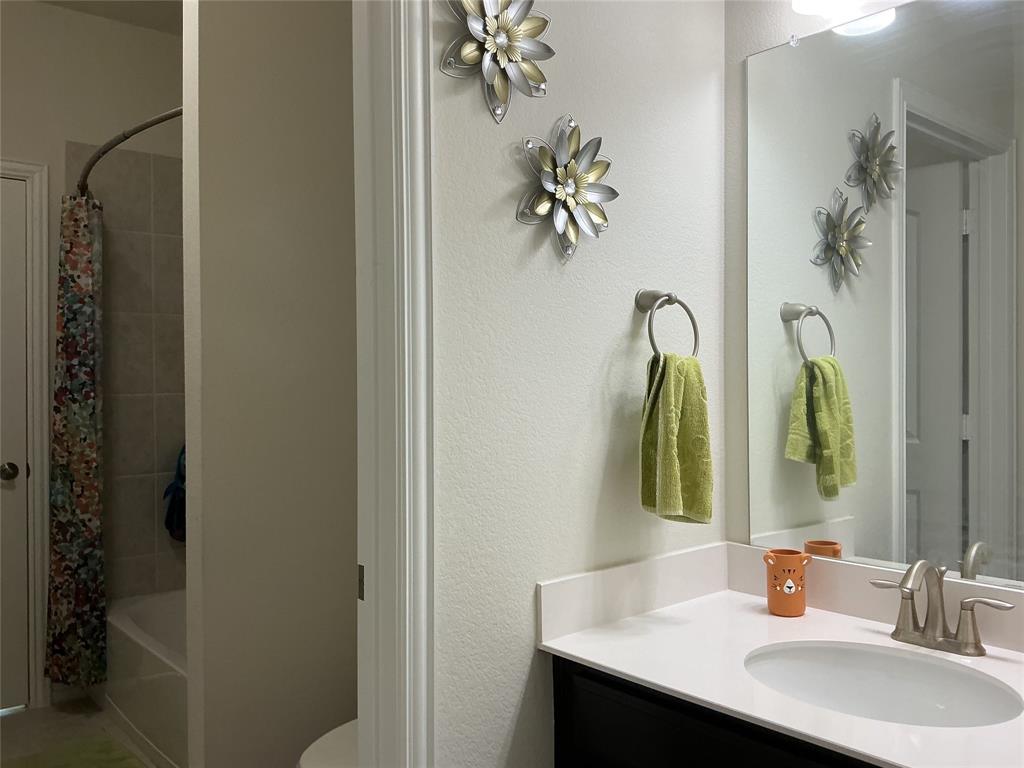 2344 Candler Club Way Little Elm, TX 75068 - Photo 11 of 14 a bathroom with a sink and a mirror