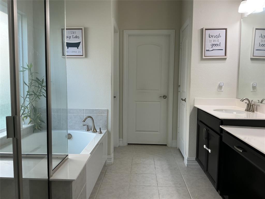2344 Candler Club Way Little Elm, TX 75068 - Photo 12 of 14 a spacious bathroom with a tub sink and mirror