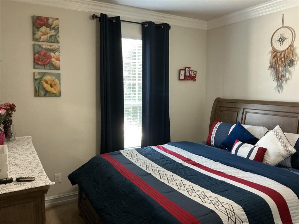 2344 Candler Club Way Little Elm, TX 75068 - Photo 5 of 14 a bedroom with a bed and cabinets