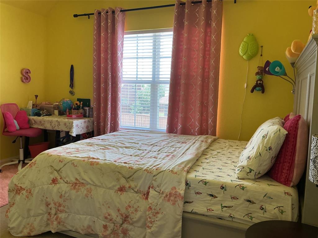 2344 Candler Club Way Little Elm, TX 75068 - Photo 7 of 14 a bedroom with a bed and chair