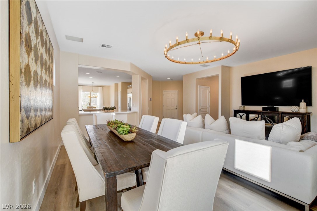2649 Rue Marquette Avenue Henderson, NV 89044 - Photo 18 of 55 This inviting dining and living area features a warm aesthetic with an open-concept flow.