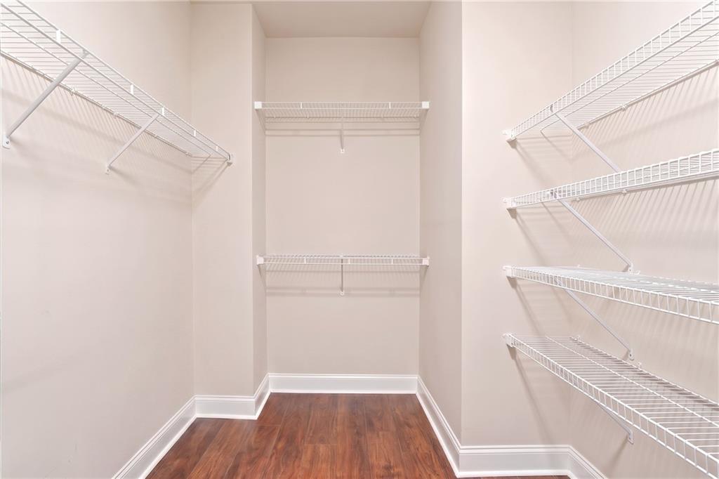 2070 Abbey Road Roswell, GA 30076 - Photo 43 of 65 a view of walk in closet with wooden floor