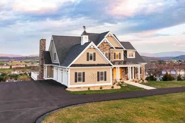 front view of a brick house with a yard