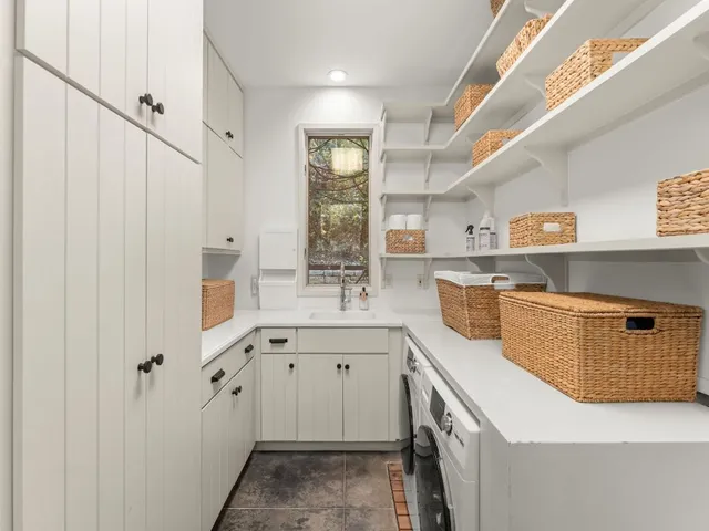 a kitchen with granite countertop a sink a stove and cabinets