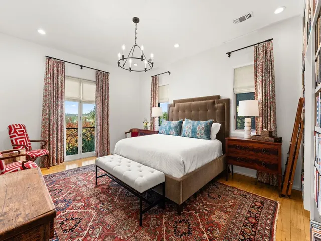 a bed room with a bed and a chandelier