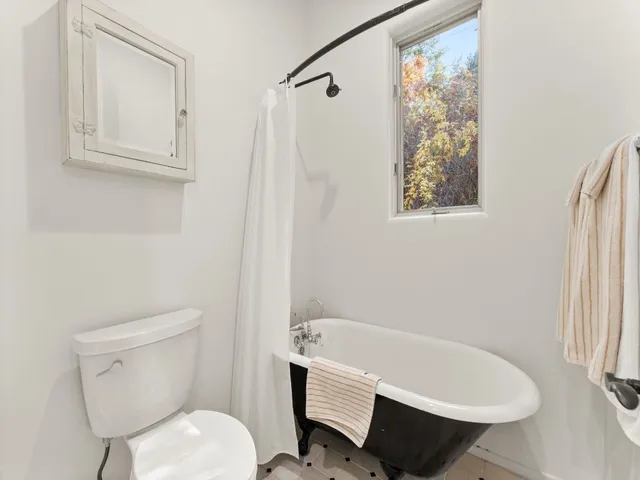 a bathroom with a toilet bathtub and shower