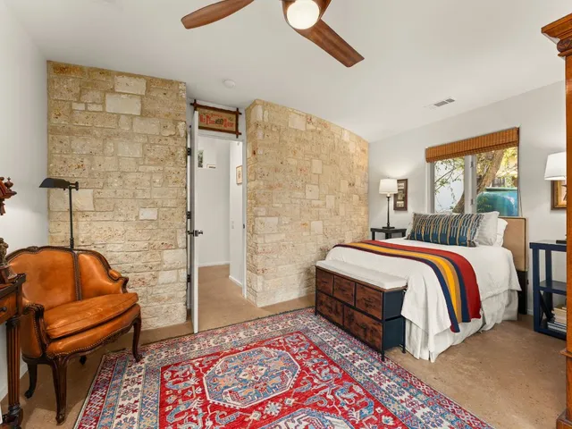 a bedroom with a bed and lamp