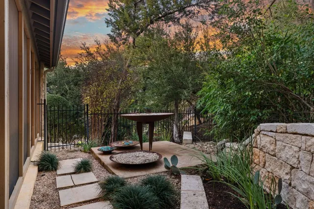 a view of backyard with plants and outdoor seating