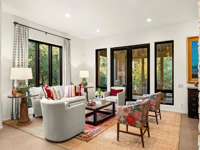 a living room with furniture and large windows