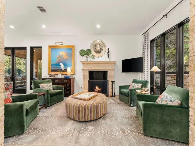 a living room with furniture a fireplace and a flat screen tv