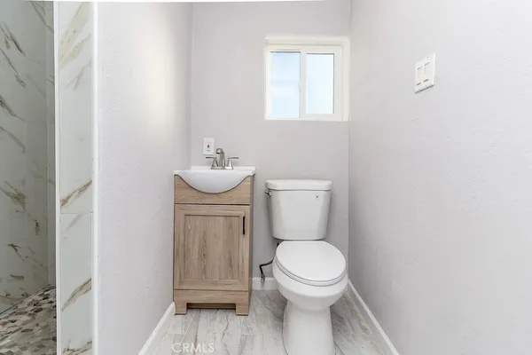 a white toilet sitting next to a bathroom sink