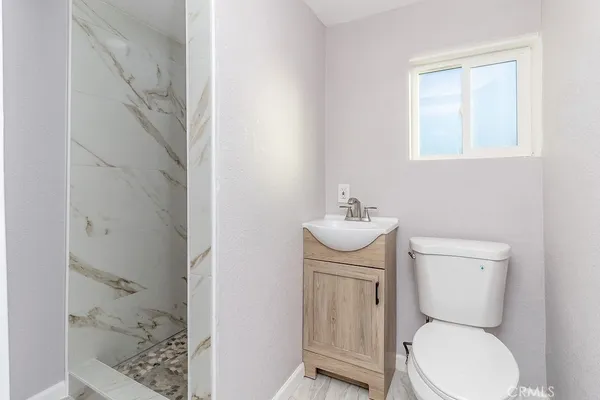 a white toilet sitting next to a bathroom sink