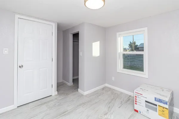 a view of room with window and wooden floor