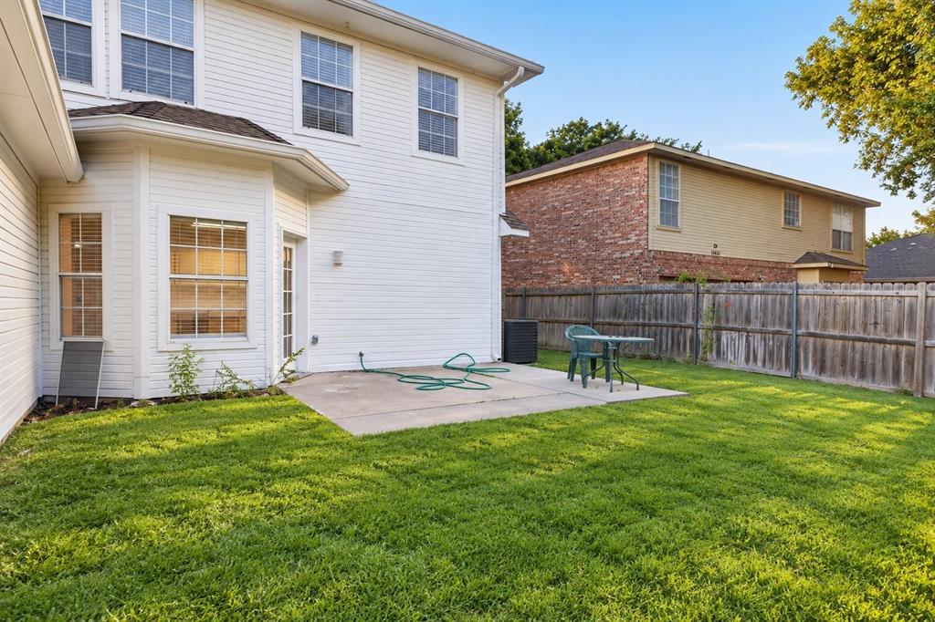 11413 Canoe Road Frisco, TX 75035 - Photo 23 of 25 Expansive grassy area with a concrete patio, wood privacy fencing, and multiple windows