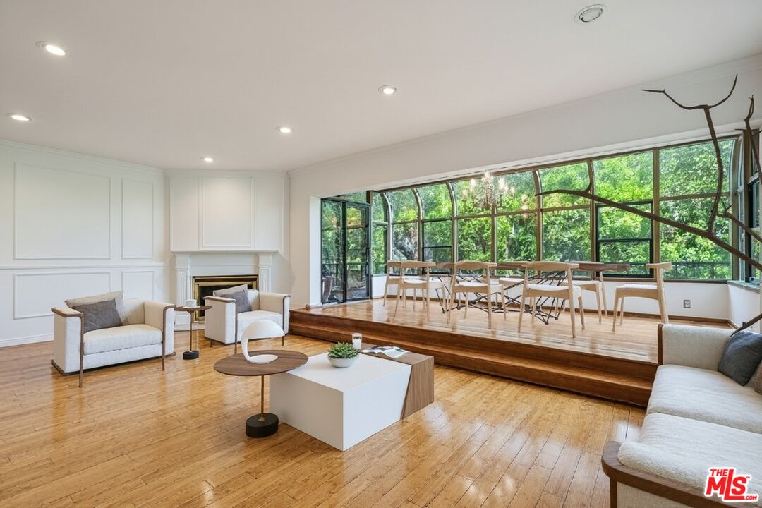 1124 North Kings Road, Unit 102 West Hollywood, CA 90069 - Photo 1 of 26 a living room with furniture and a large window