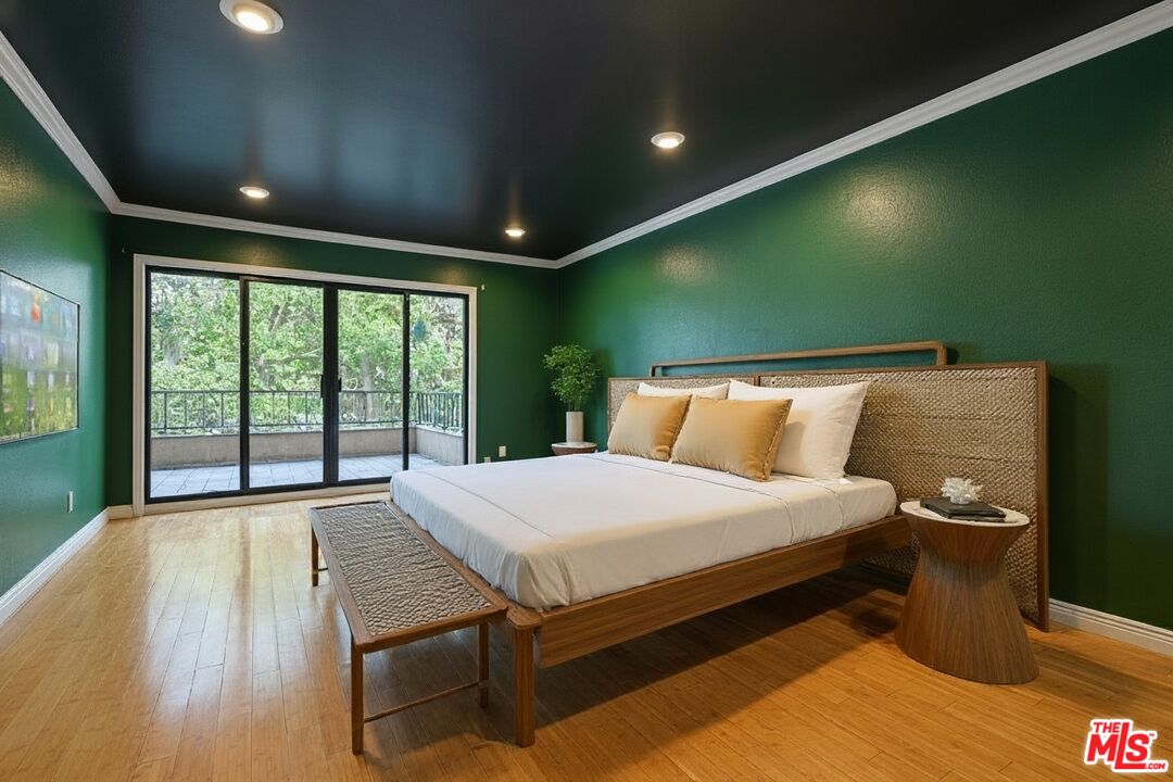 1124 North Kings Road, Unit 102 West Hollywood, CA 90069 - Photo 12 of 26 a bed sitting in a room next to a large window
