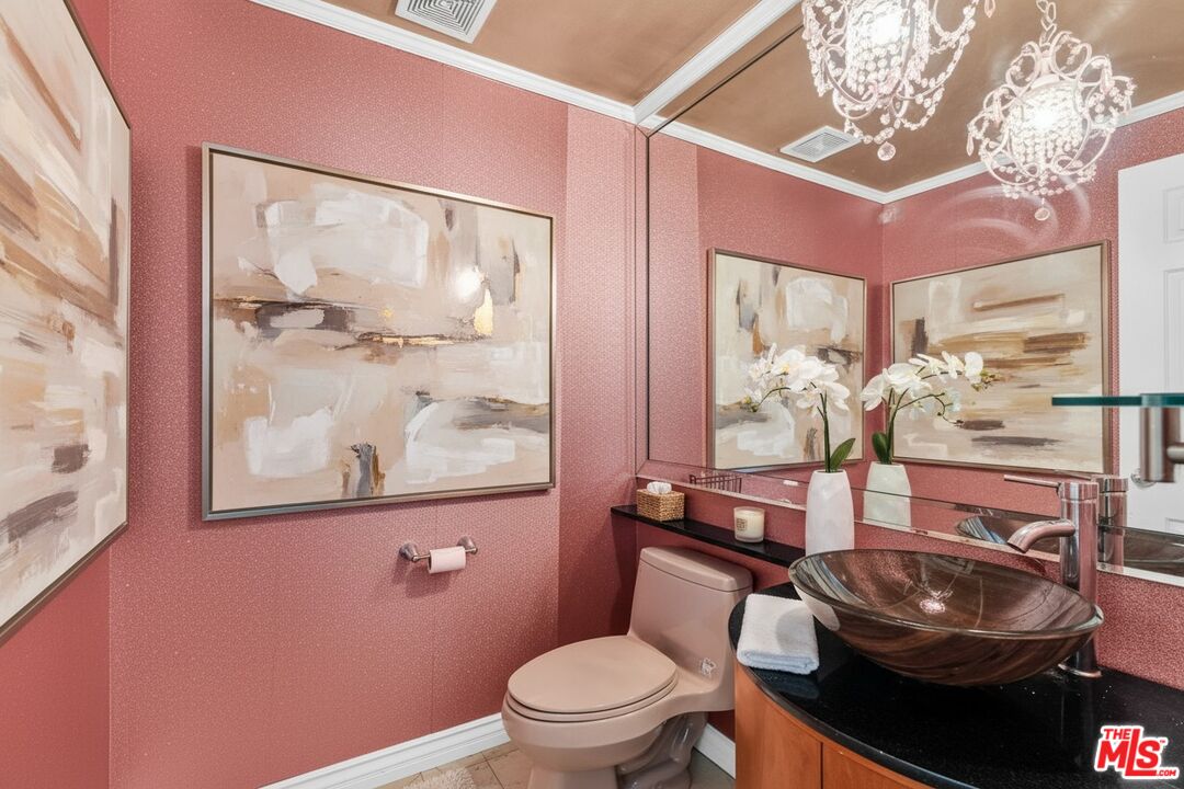 1124 North Kings Road, Unit 102 West Hollywood, CA 90069 - Photo 13 of 26 a bathroom with a toilet a sink and a mirror