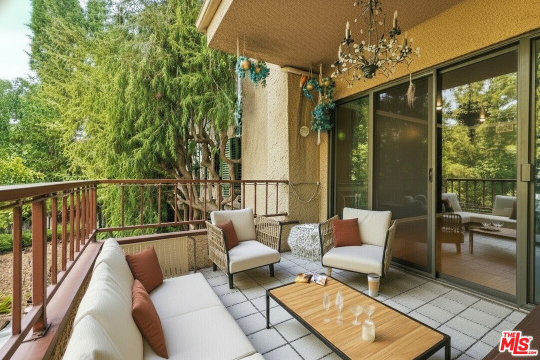 1124 North Kings Road, Unit 102 West Hollywood, CA 90069 - Photo 18 of 26 a balcony with furniture and a potted plant