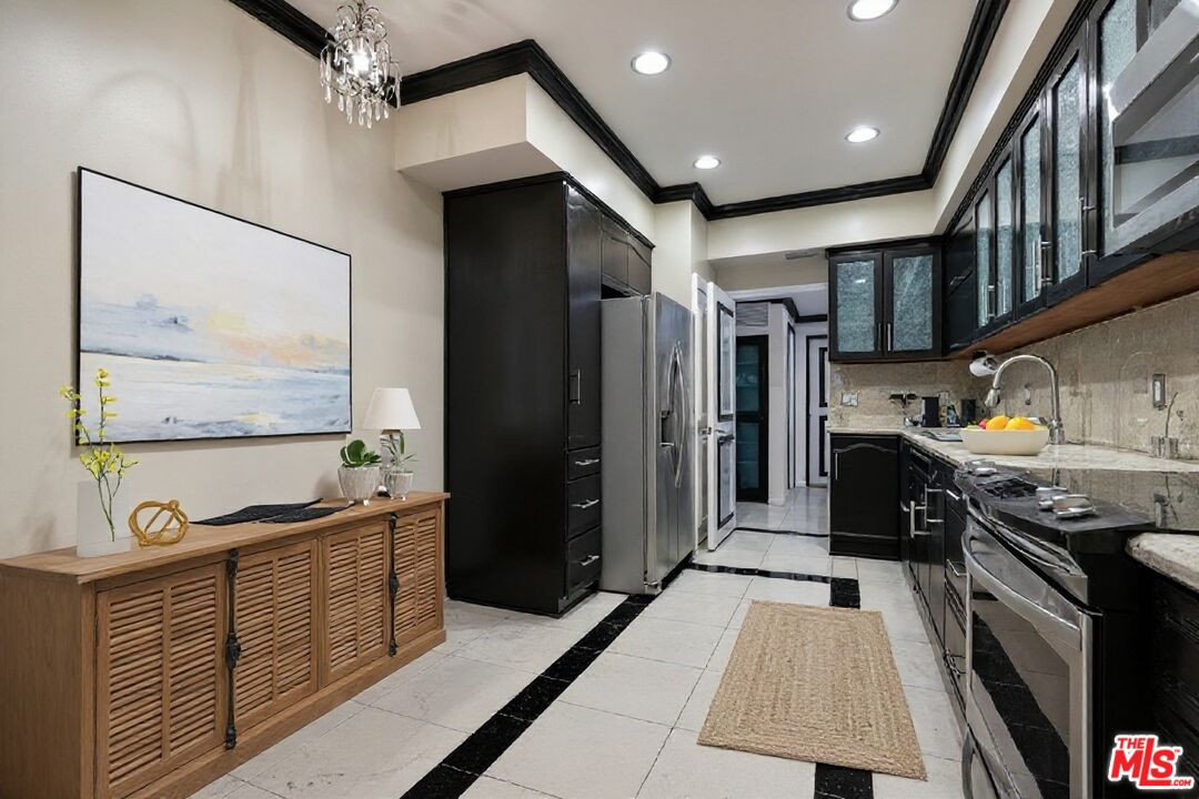 1124 North Kings Road, Unit 102 West Hollywood, CA 90069 - Photo 2 of 26 a kitchen with stainless steel appliances granite countertop a stove a sink and a refrigerator