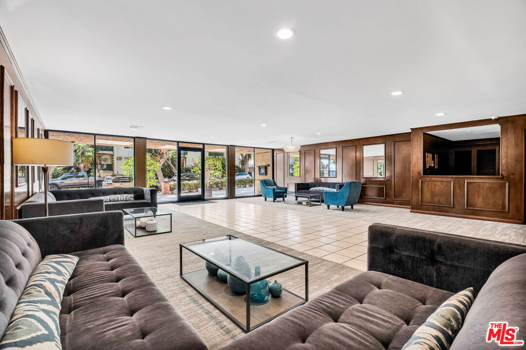 1124 North Kings Road, Unit 102 West Hollywood, CA 90069 - Photo 23 of 26 a living room with furniture and a flat screen tv