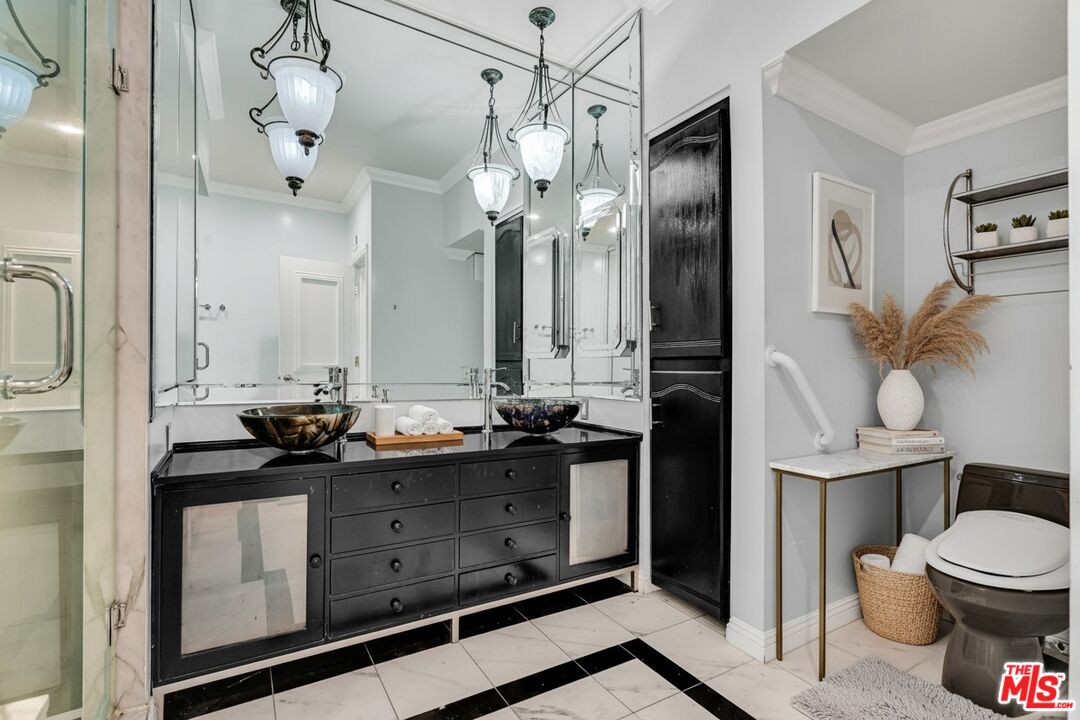 1124 North Kings Road, Unit 102 West Hollywood, CA 90069 - Photo 4 of 26 a bathroom with a granite countertop sink a toilet a mirror and shower