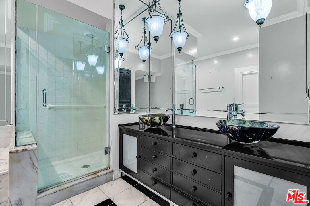 1124 North Kings Road, Unit 102 West Hollywood, CA 90069 - Photo 5 of 26 a bathroom with a granite countertop sink a shower and a mirror