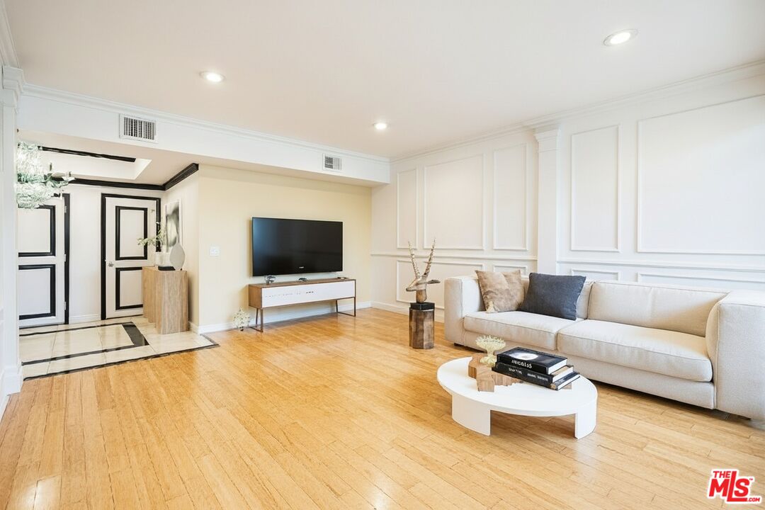 1124 North Kings Road, Unit 102 West Hollywood, CA 90069 - Photo 7 of 26 a living room with furniture and a flat screen tv