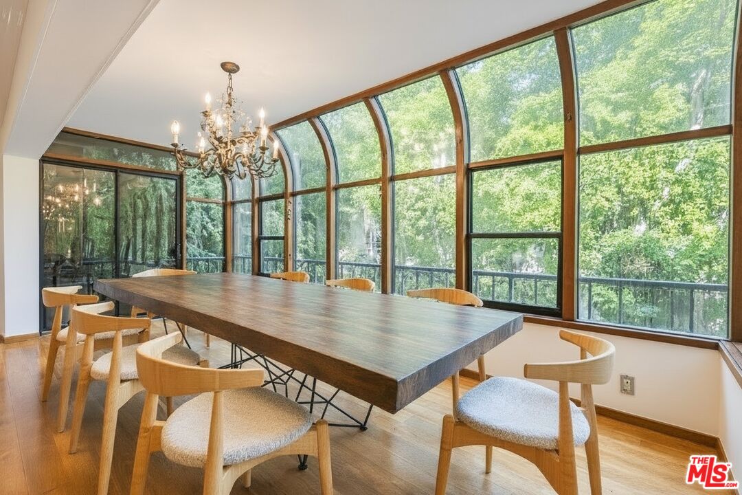 1124 North Kings Road, Unit 102 West Hollywood, CA 90069 - Photo 10 of 26 a view of a dining room with furniture window and wooden floor