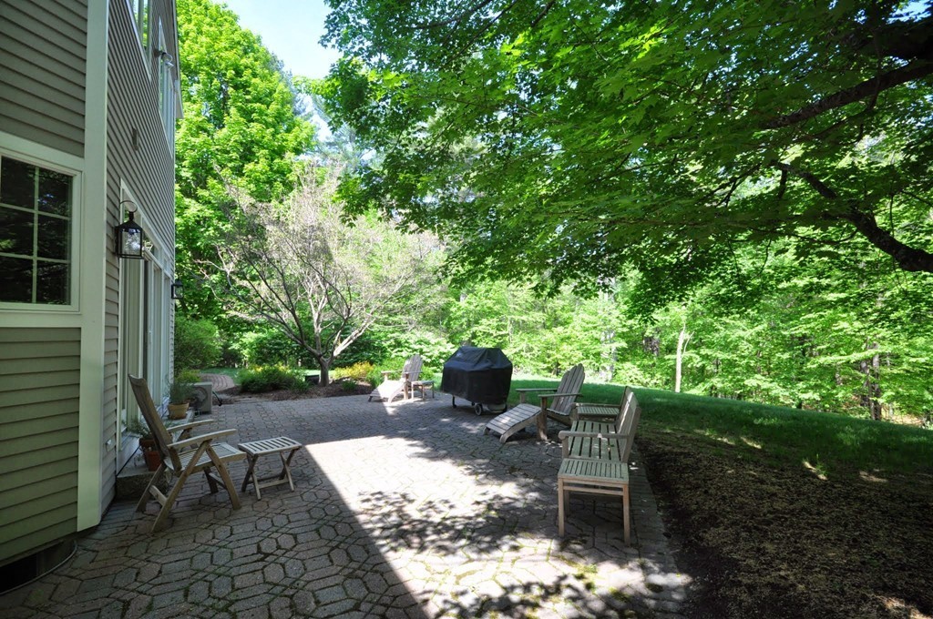 75 Channing Road Concord, MA 01742 - Photo 18 of 19 a view of a patio with table and chairs and potted plants