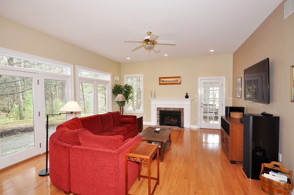 75 Channing Road Concord, MA 01742 - Photo 6 of 19 a living room with furniture a fireplace and a flat screen tv