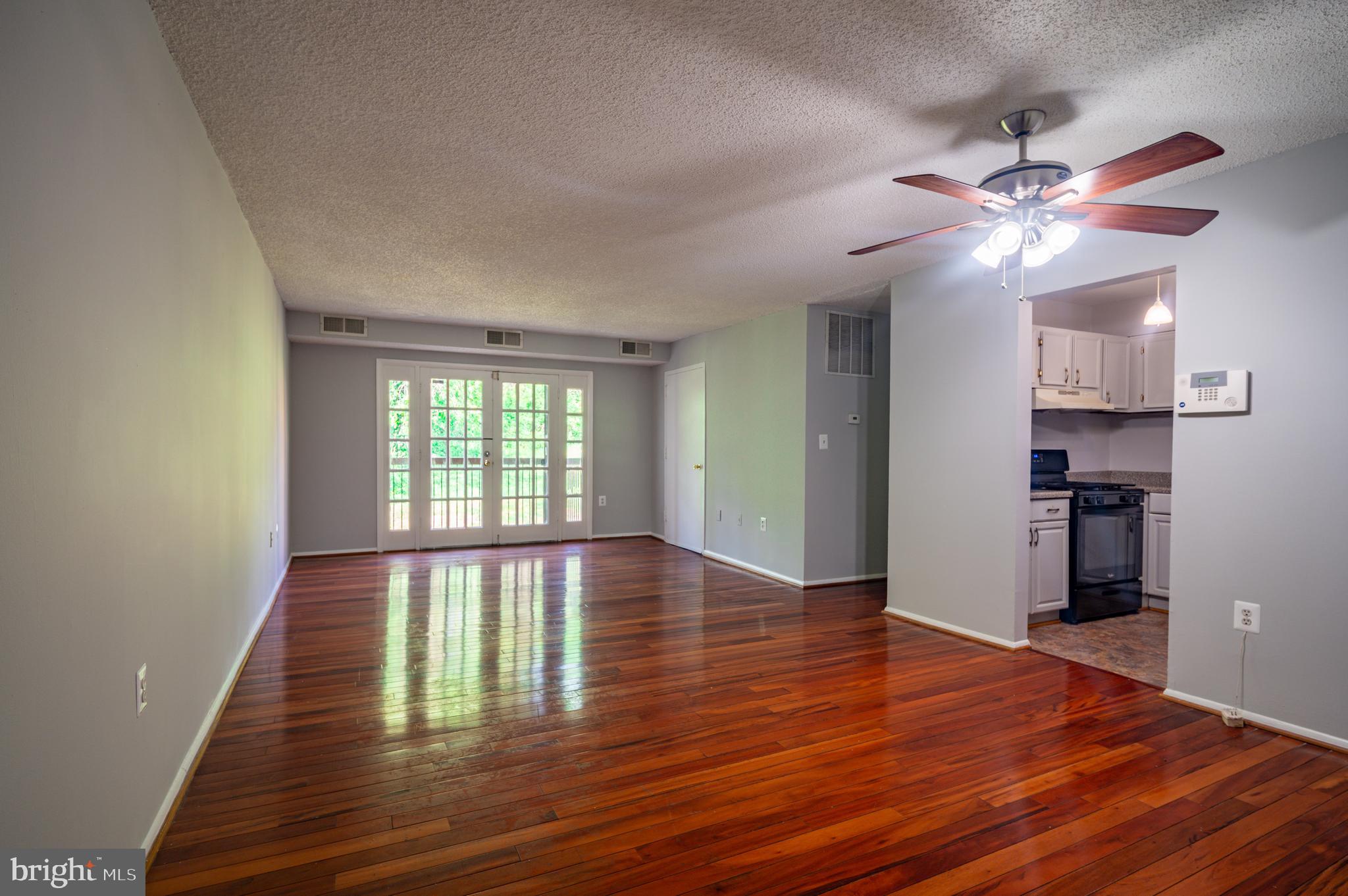3815 Swann Road, Unit 103 Suitland, MD 20746 - Photo 2 of 23 a view of empty room with wooden floor and fan