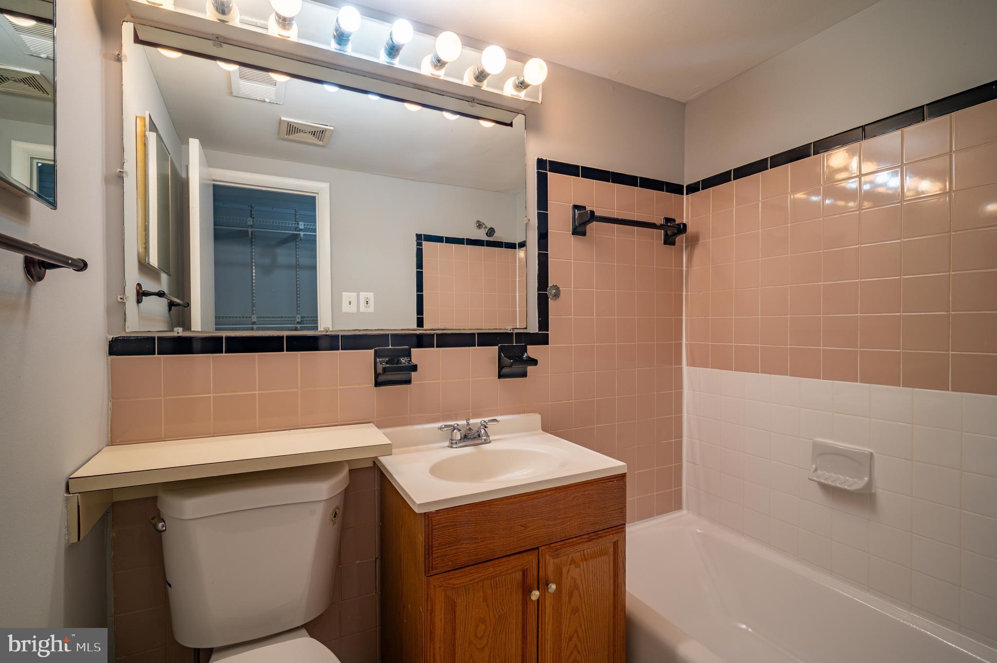 3815 Swann Road, Unit 103 Suitland, MD 20746 - Photo 21 of 23 a bathroom with a sink a toilet and a bathtub