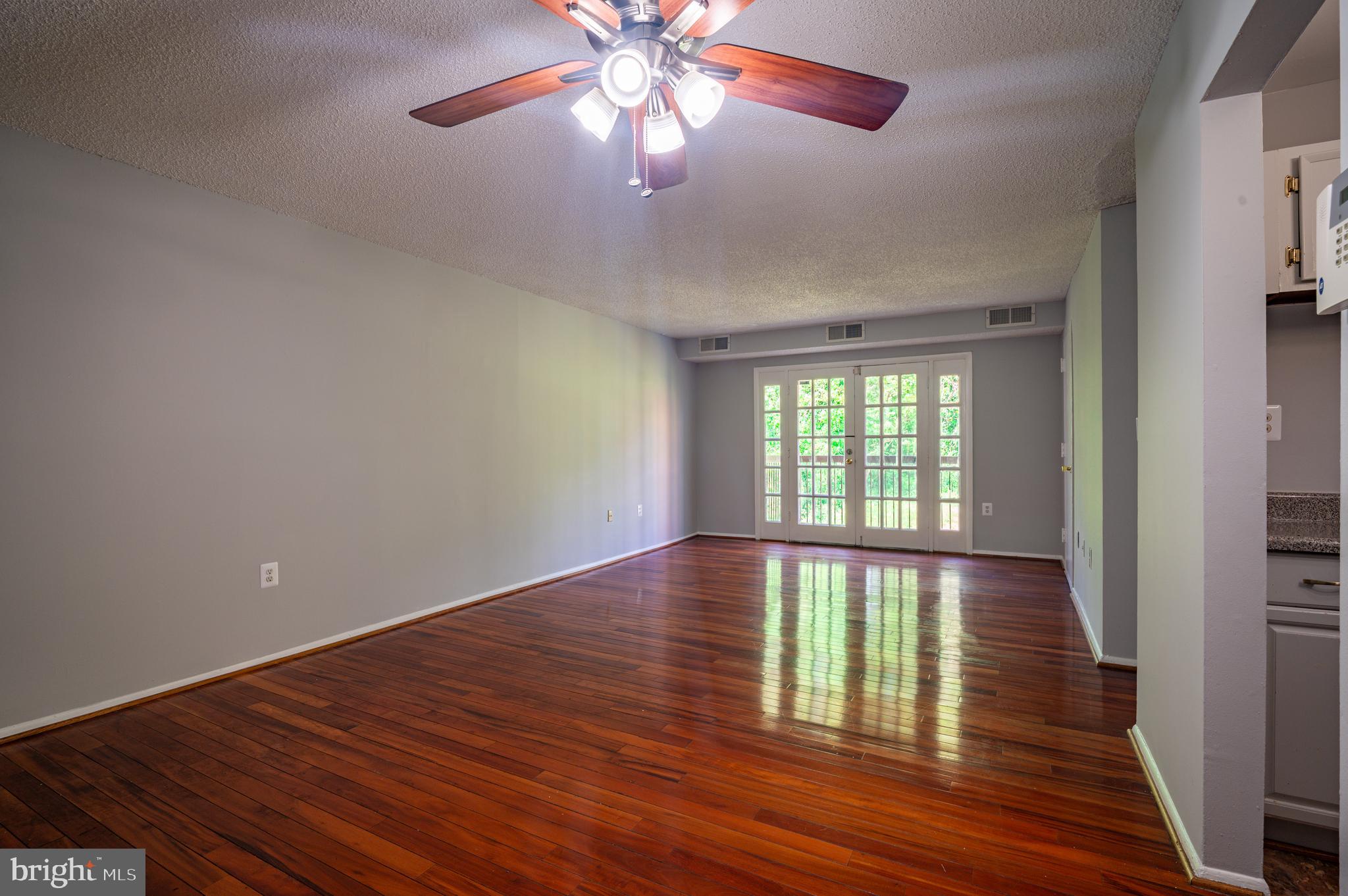 3815 Swann Road, Unit 103 Suitland, MD 20746 - Photo 3 of 23 wooden floor in an empty room with a window