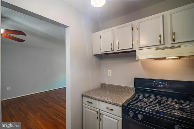 a kitchen with wooden cabinets and a stove top oven