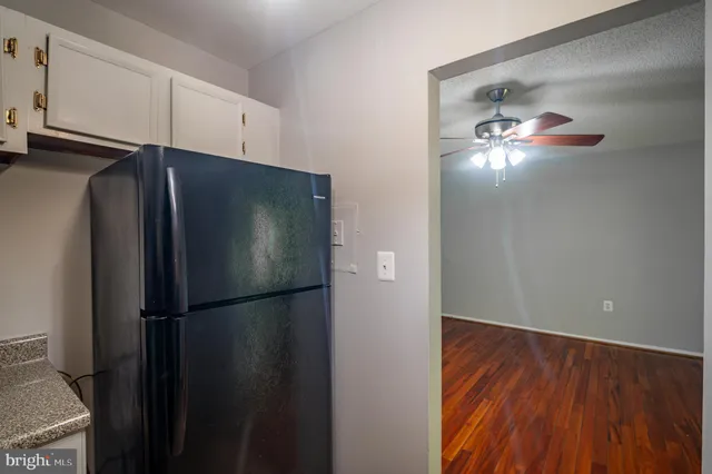 a metallic refrigerator freezer sitting in a kitchen