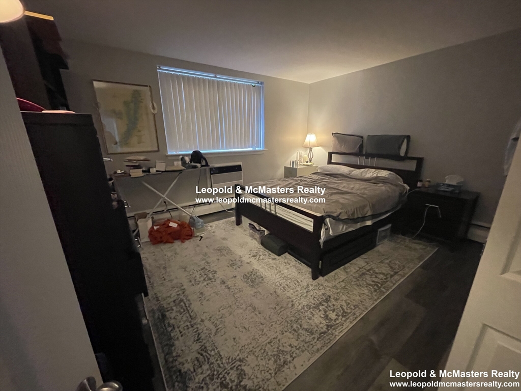 519 Washington Street, Unit 0A Brookline, MA 02446 - Photo 4 of 9 a bedroom with a bed window and chair