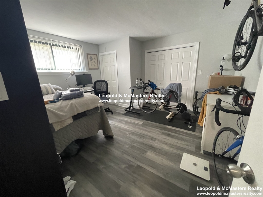 519 Washington Street, Unit 0A Brookline, MA 02446 - Photo 5 of 9 a living room with furniture a window and gym equipment