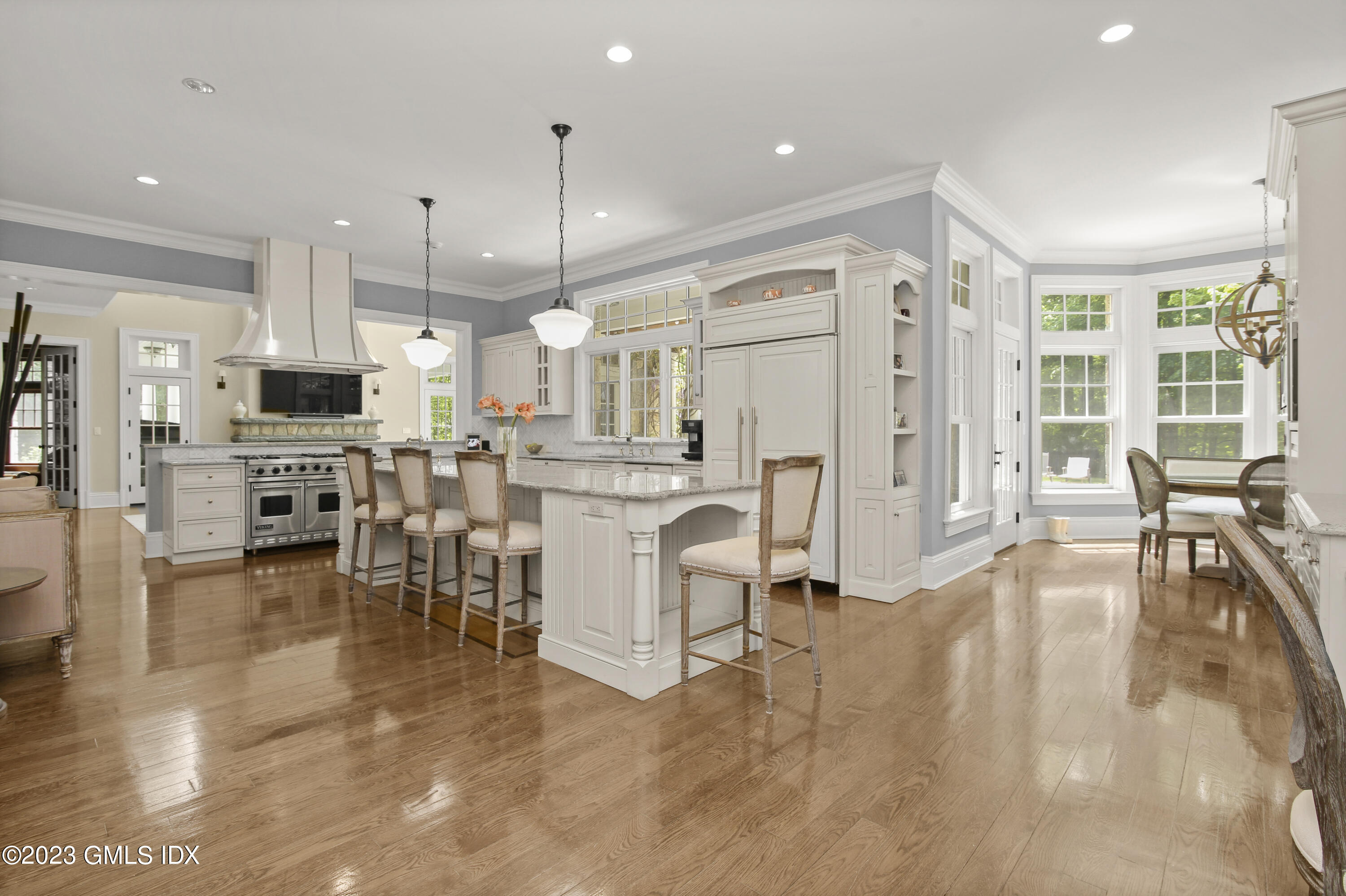 39 Boulder Brook Road Greenwich, CT 06830 - Photo 16 of 55 a large white kitchen with lots of counter space dining table and chairs