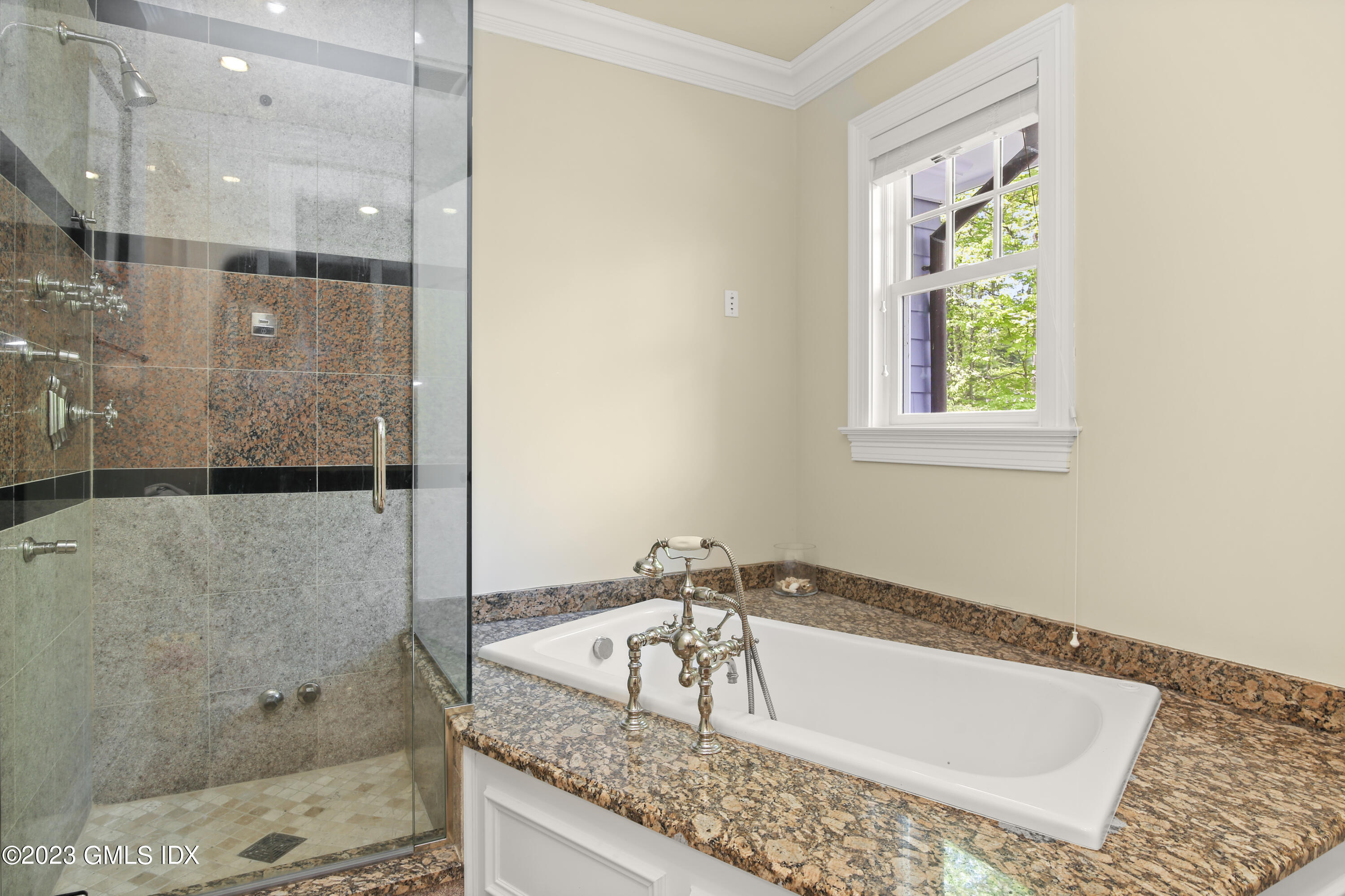 39 Boulder Brook Road Greenwich, CT 06830 - Photo 31 of 55 a bathroom with a granite countertop bathtub and shower