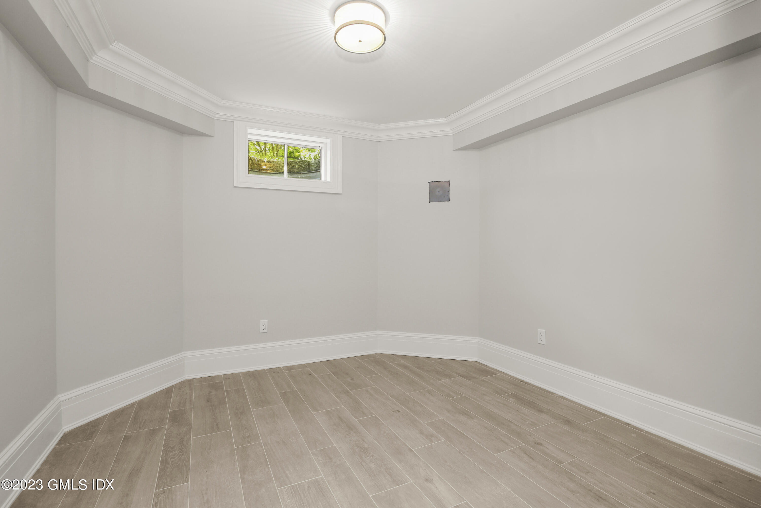 39 Boulder Brook Road Greenwich, CT 06830 - Photo 43 of 55 a view of an empty room with wooden floor and a window